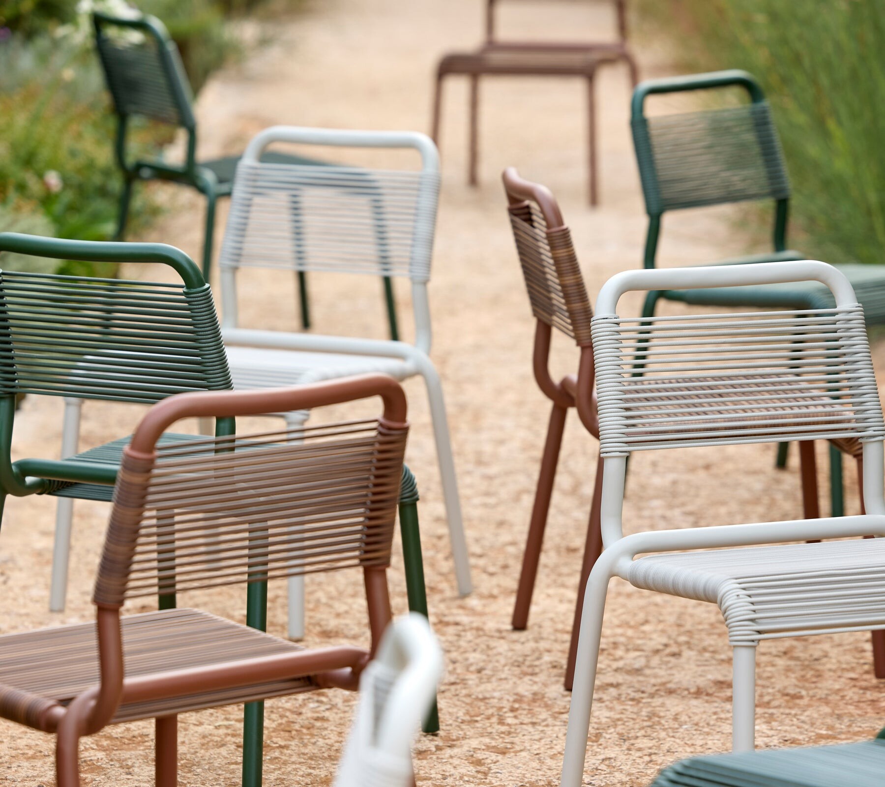 Cane-line Al Dente chairs lined up in several colors
