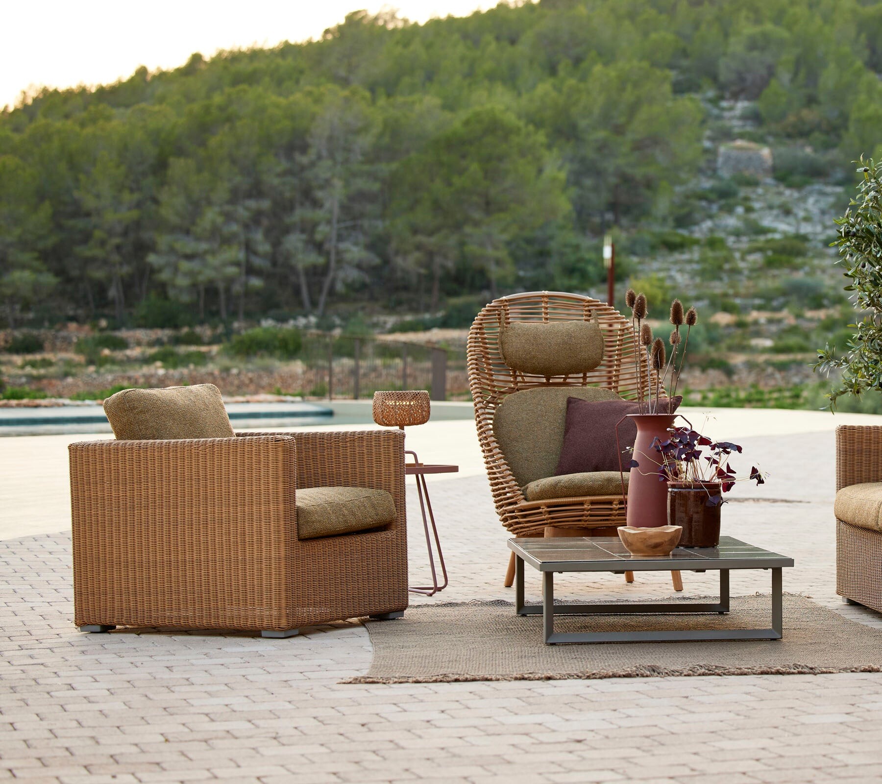 Cane-line Chester lounge chair styled in a garden