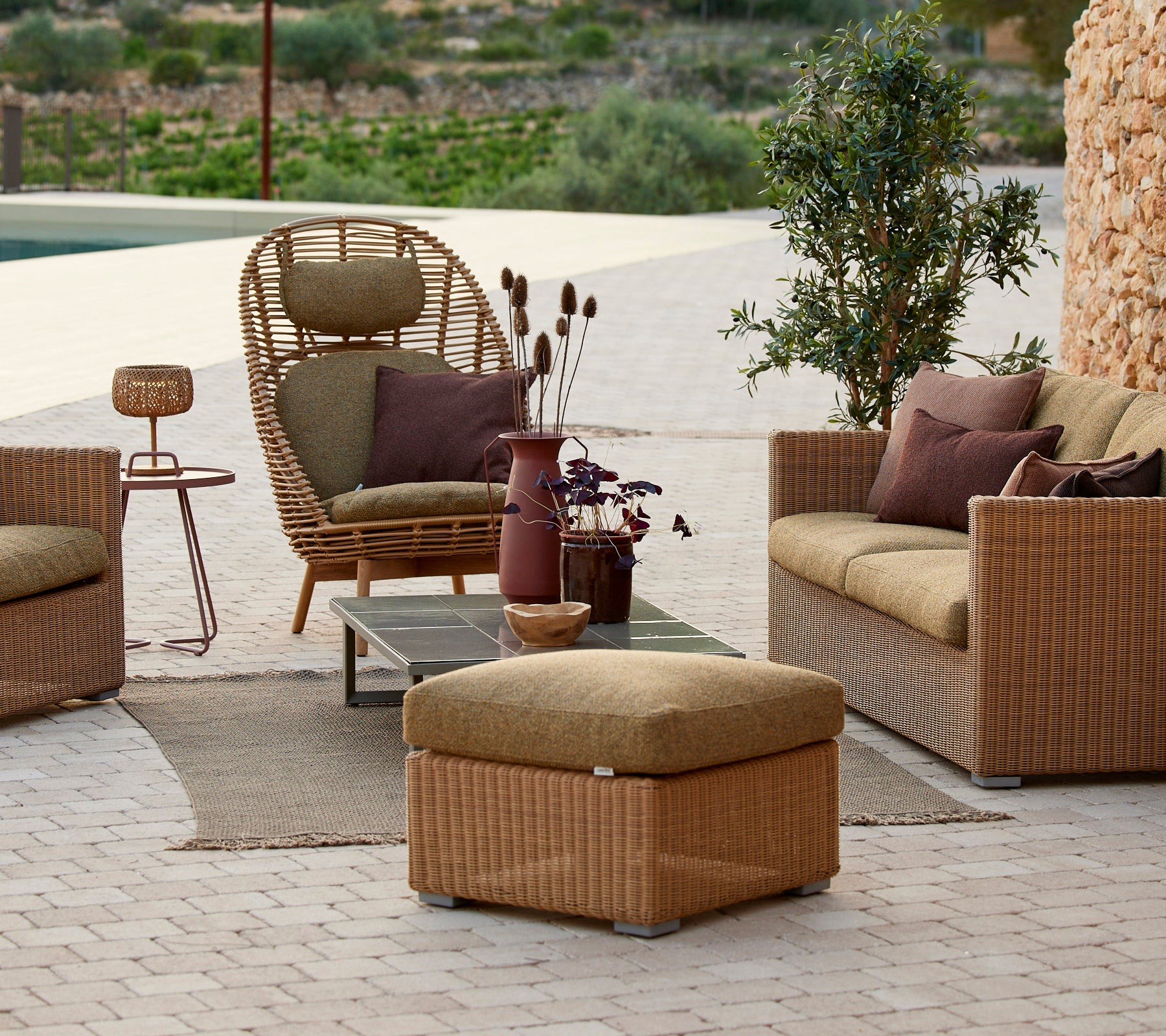 Cane-line Chester outdoor lounge collection in natural woven fibre on a terrace