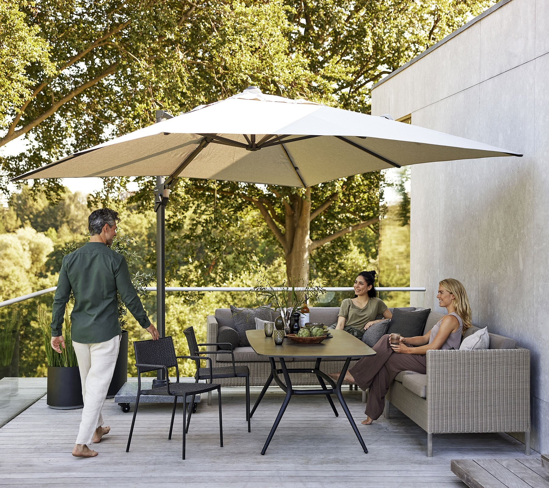 Cane-line Connect lounge and dining set under a parasol