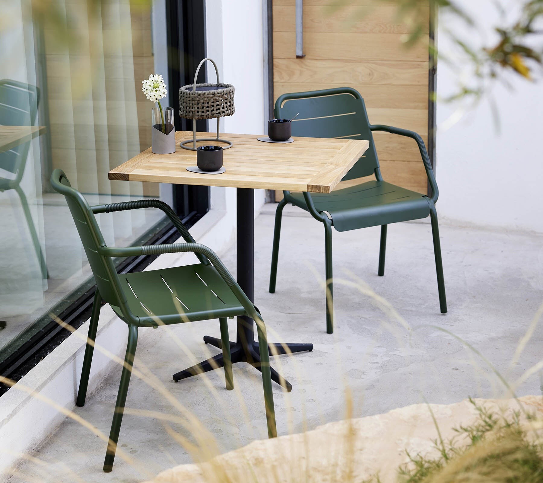 Cane-line Copenhagen armchairs at a teak cafe table