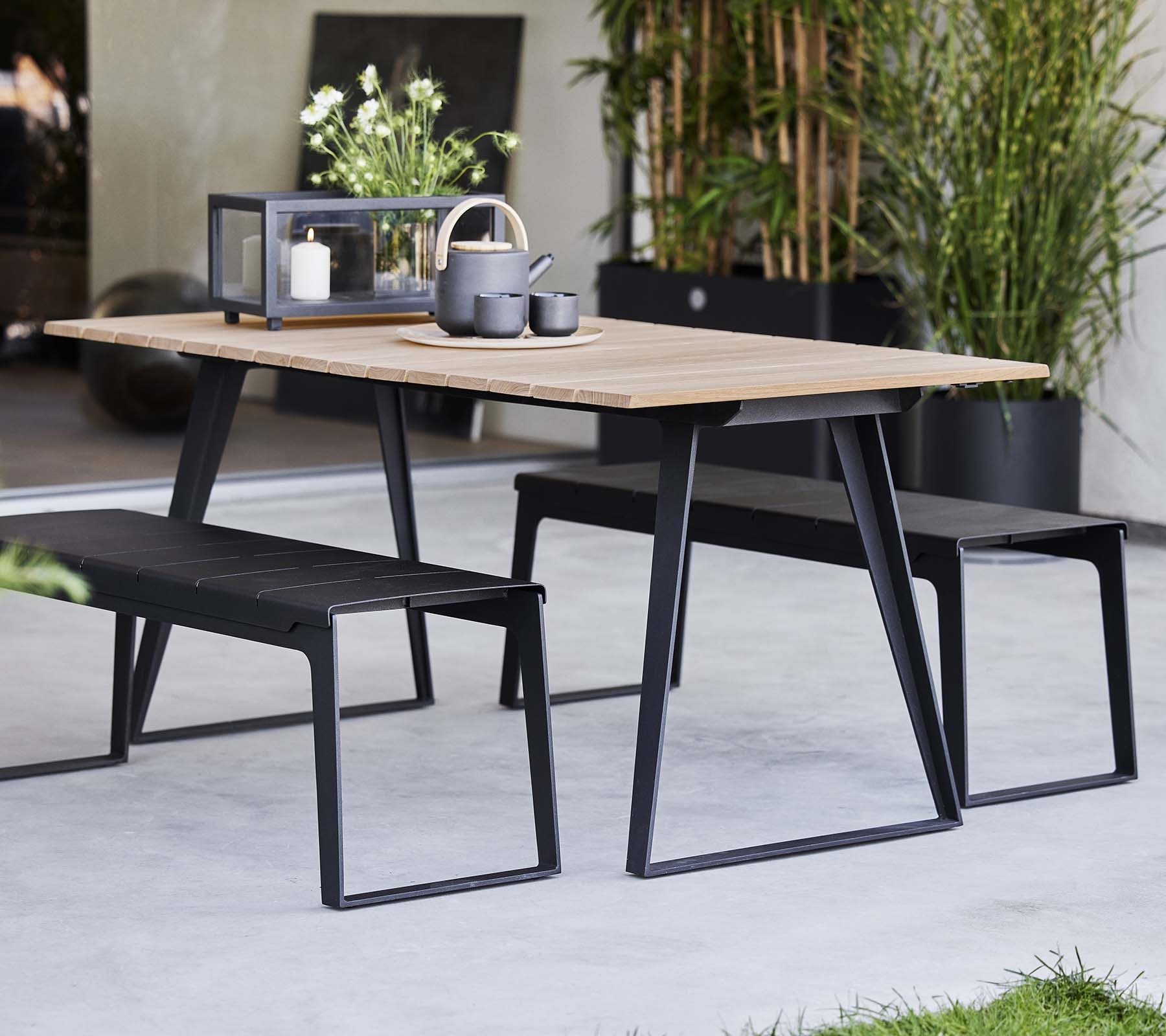 Cane-line Copenhagen outdoor teak dining table and benches on a terrace