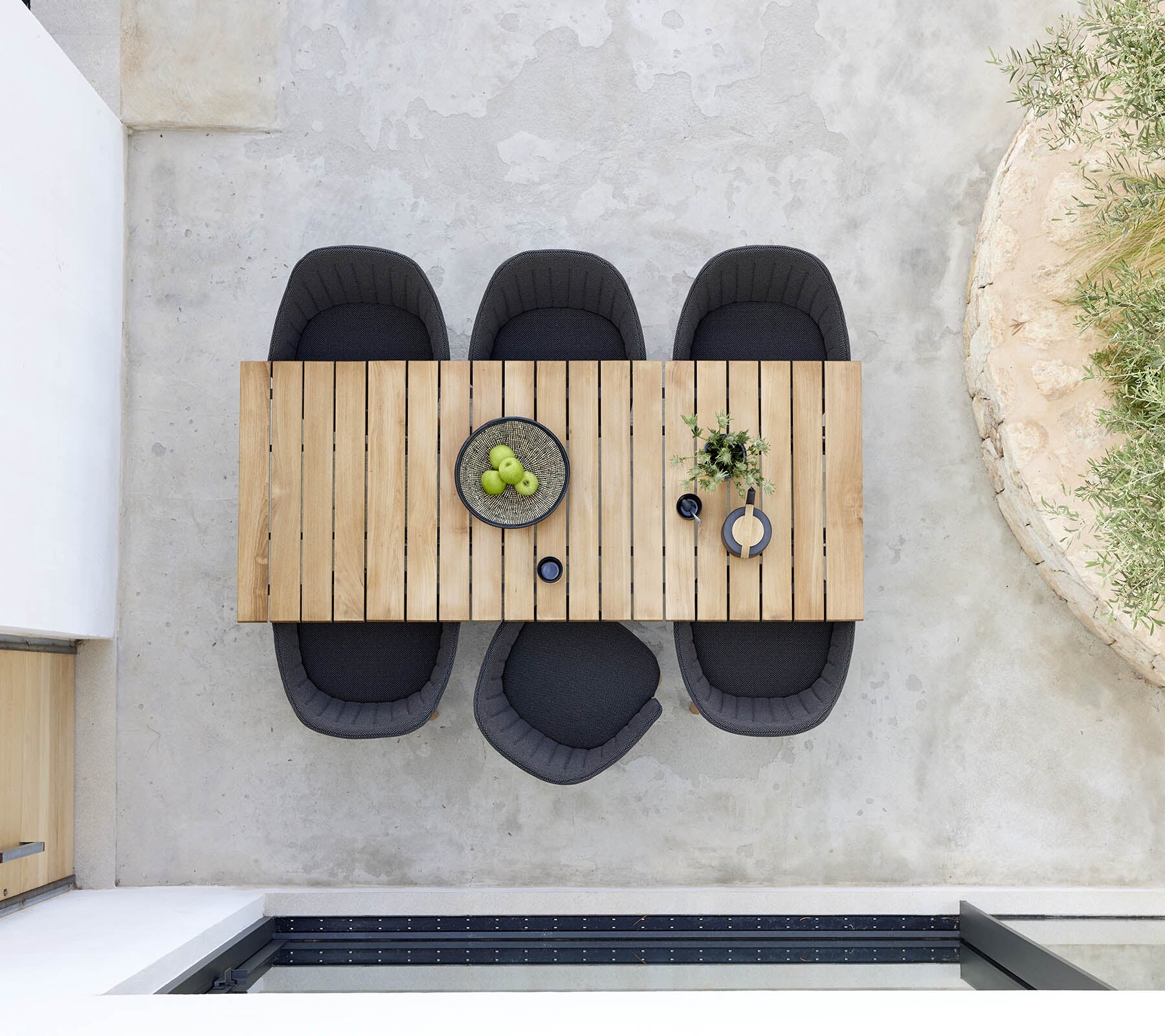 Cane-line Core dining table set with tableware on a terrace