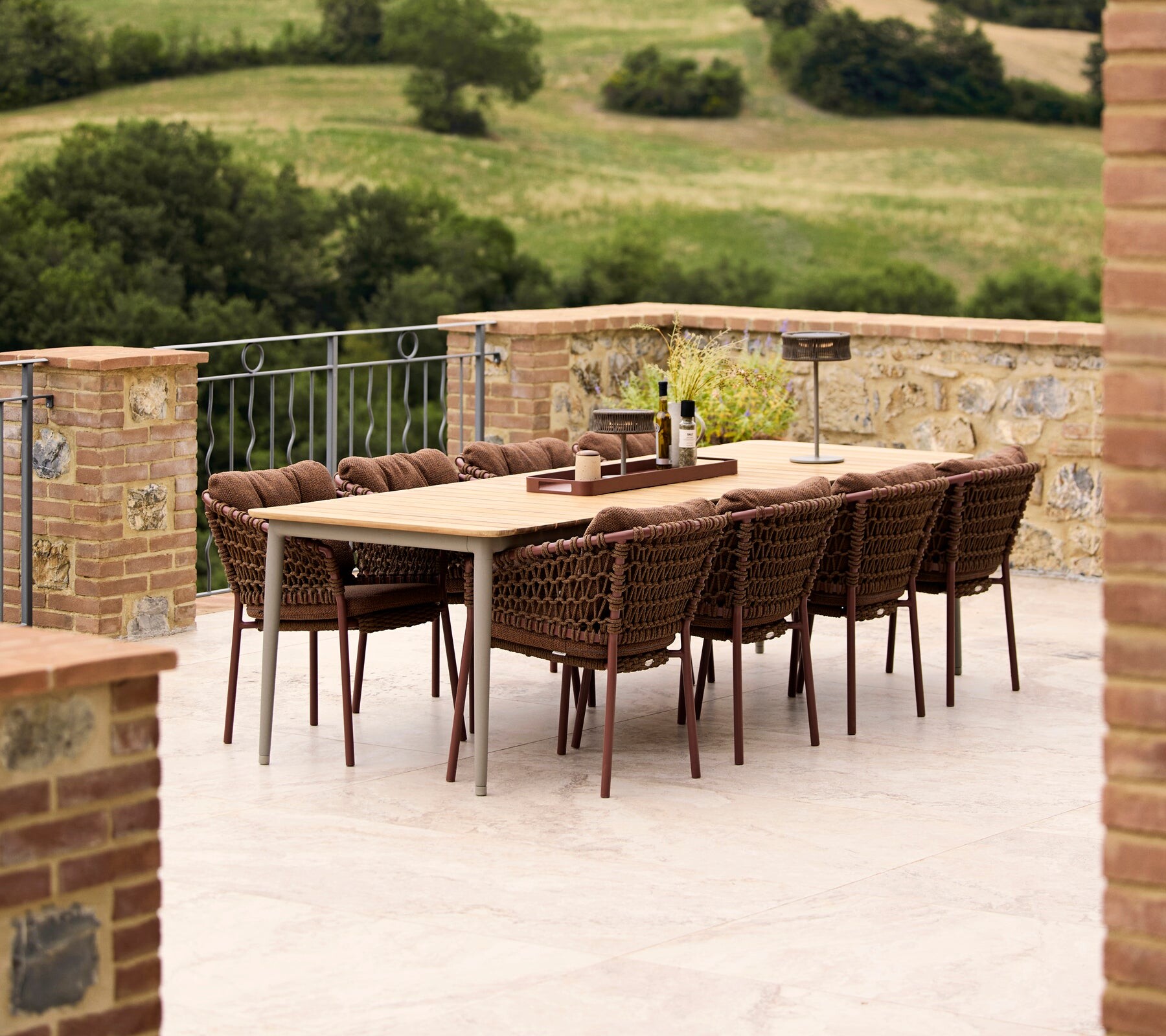 Cane-line Core teak dining set on a hillside terrace