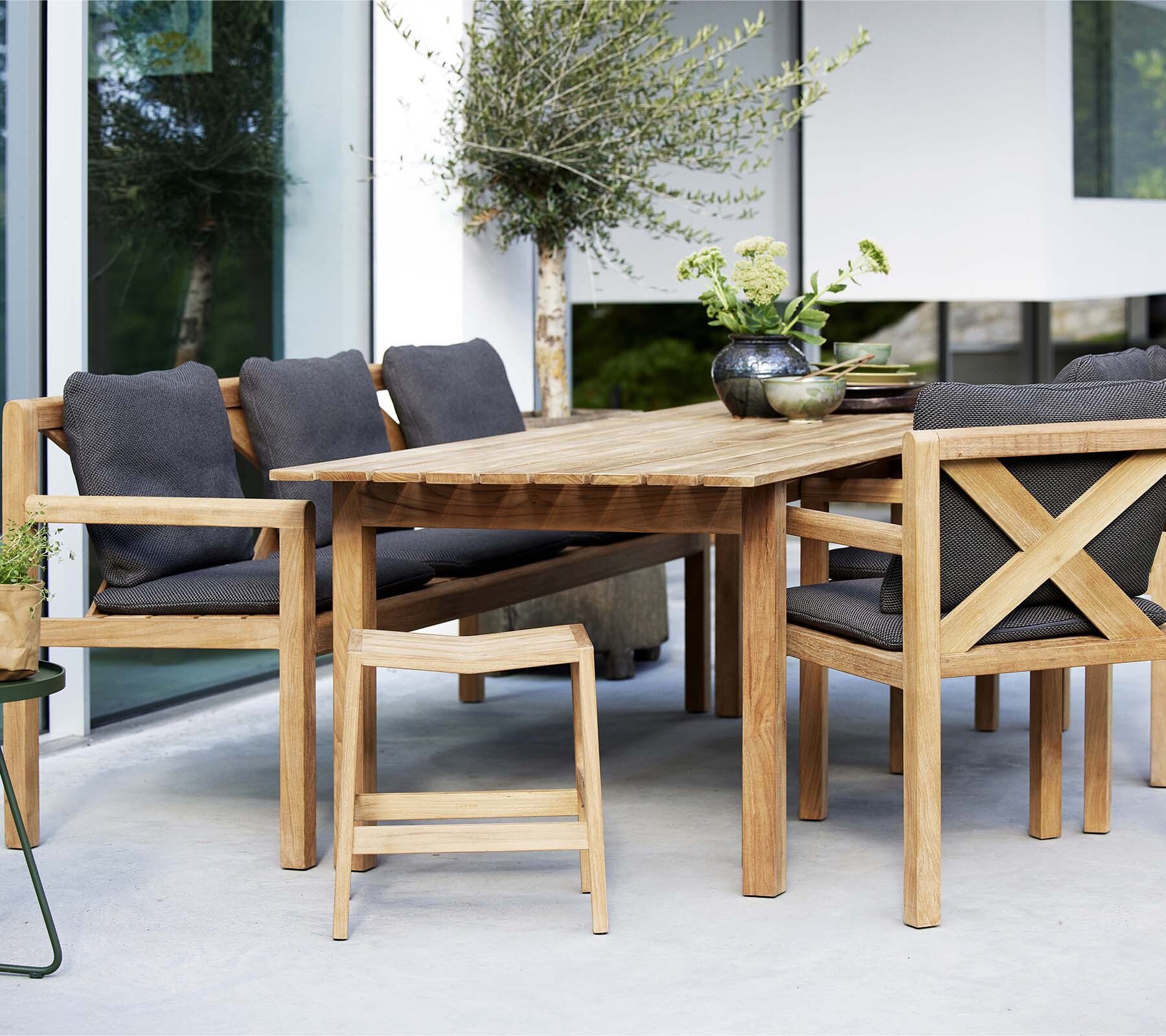 Cane-line Grace teak dining set beside a garden room