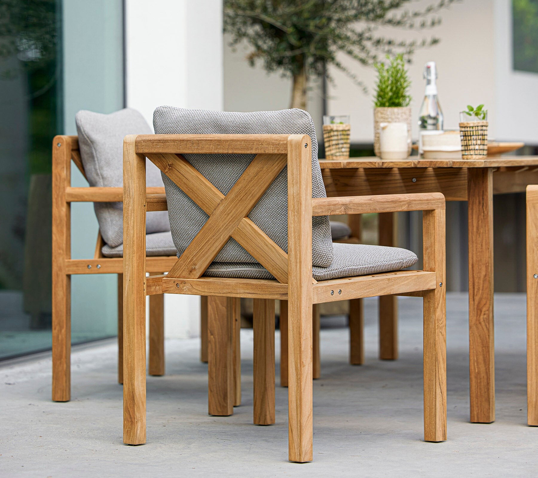 Cane-line Grace teak dining chair and table styled outdoors