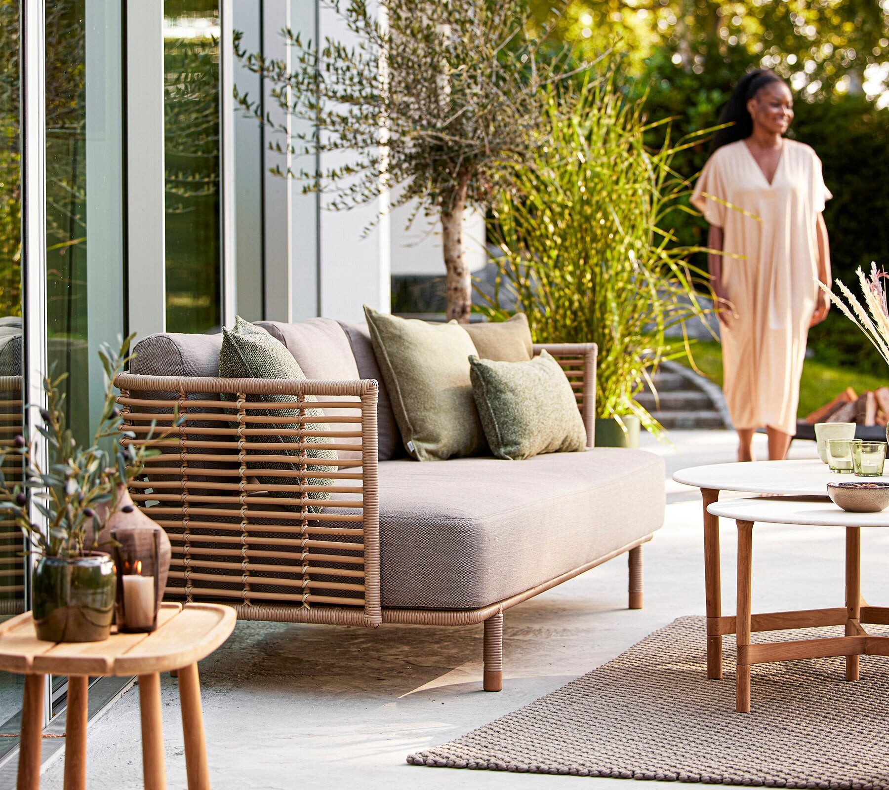 Cane-line Sense sofa and side tables styled in a garden