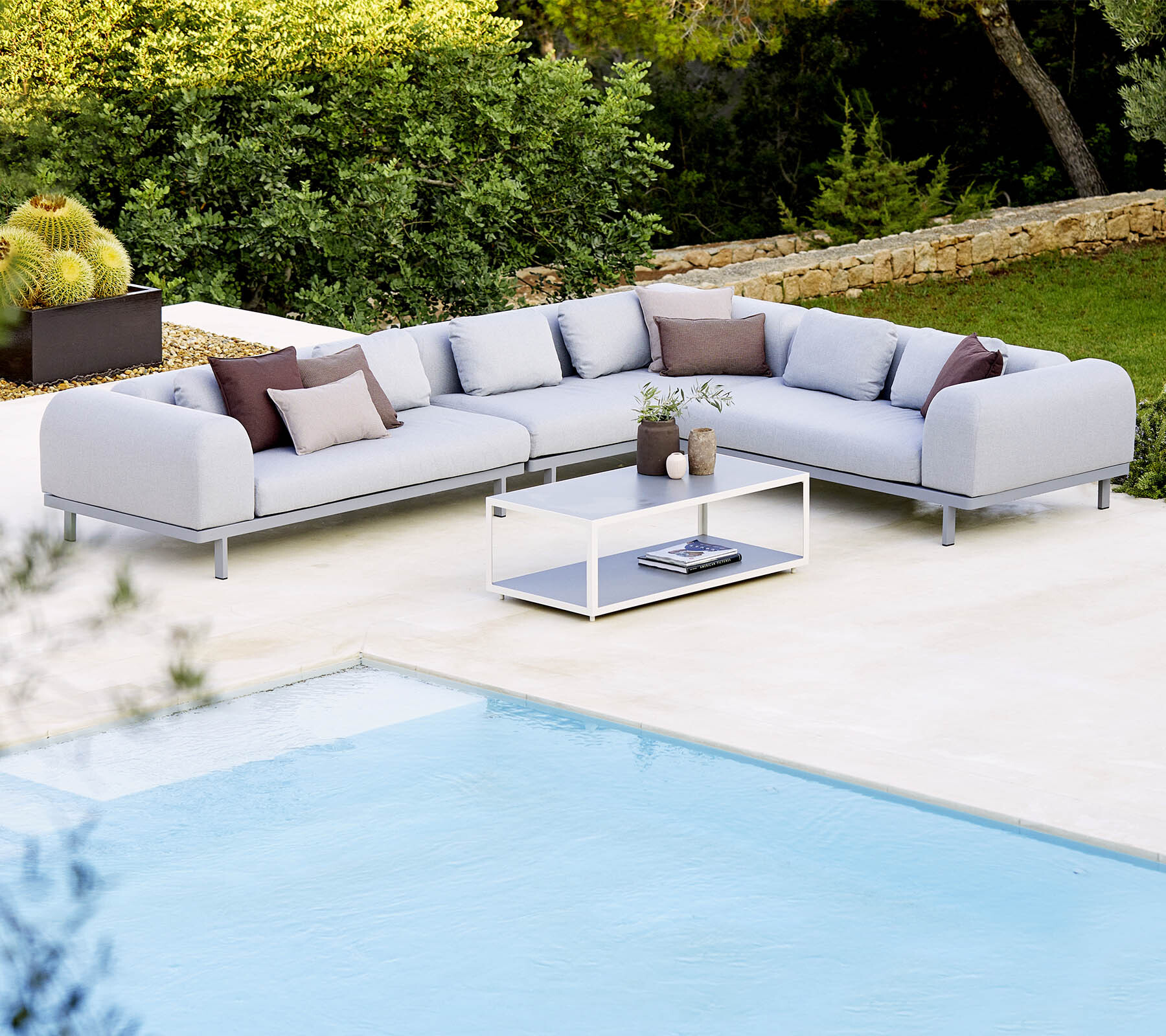 Cane-line Space modular corner sofa by a pool