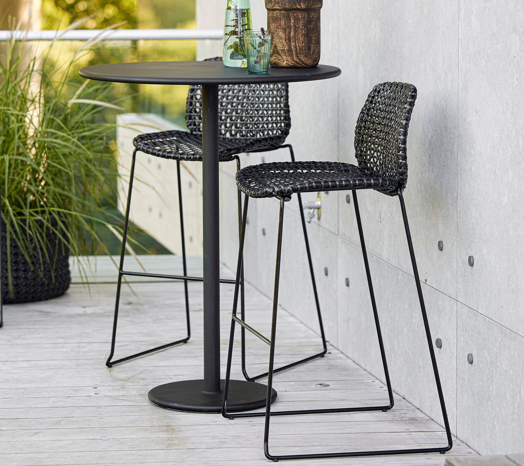 Cane-line Vibe bar chairs at an outdoor bar table