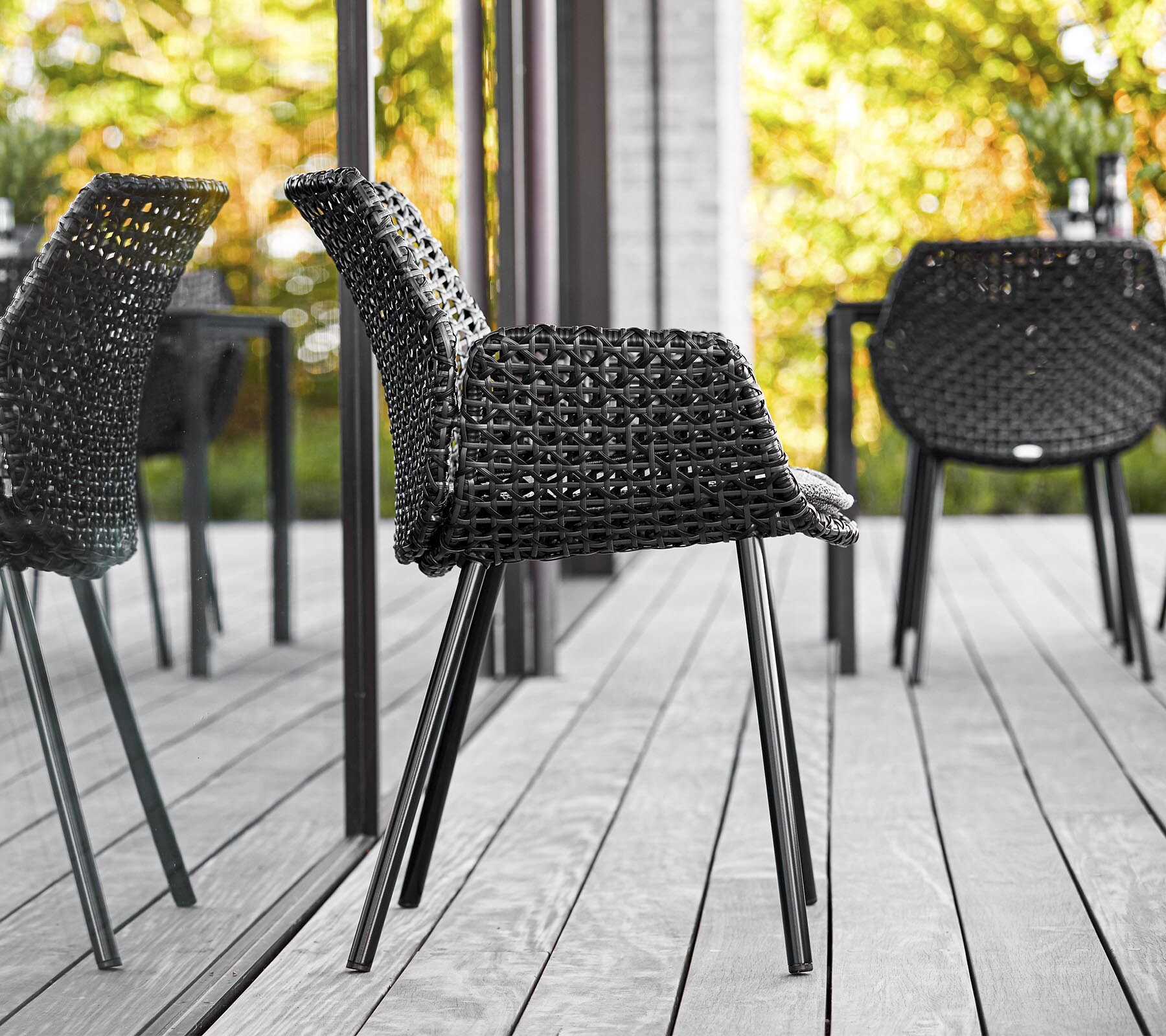Cane-line Vibe chairs on a wood deck