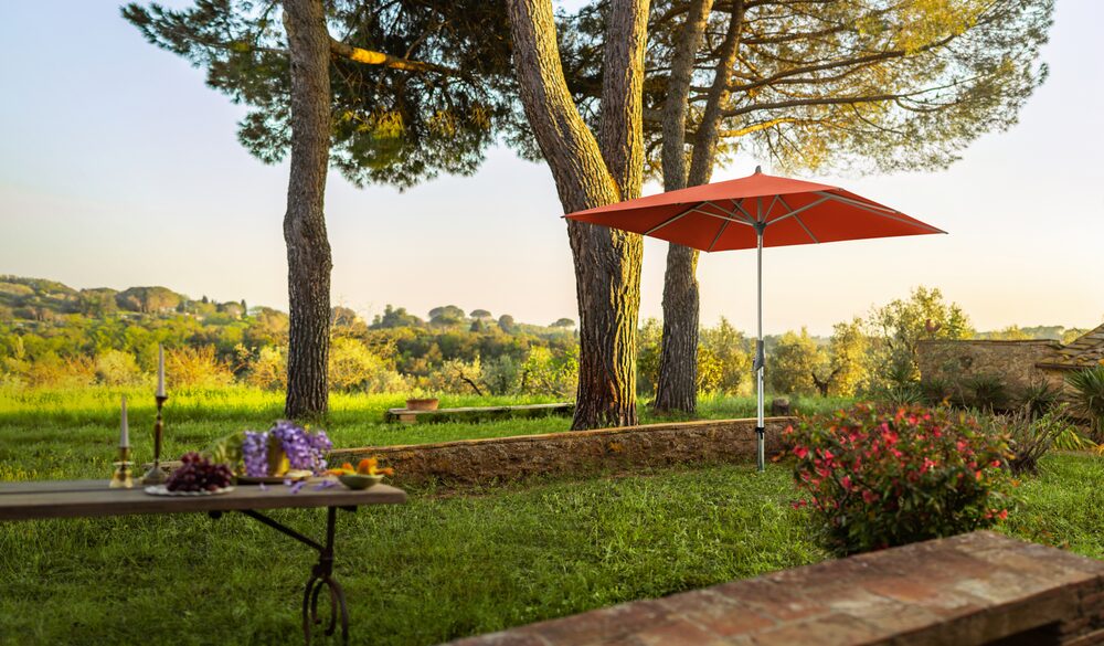 Alu-Twist parasol in a garden orchard setting