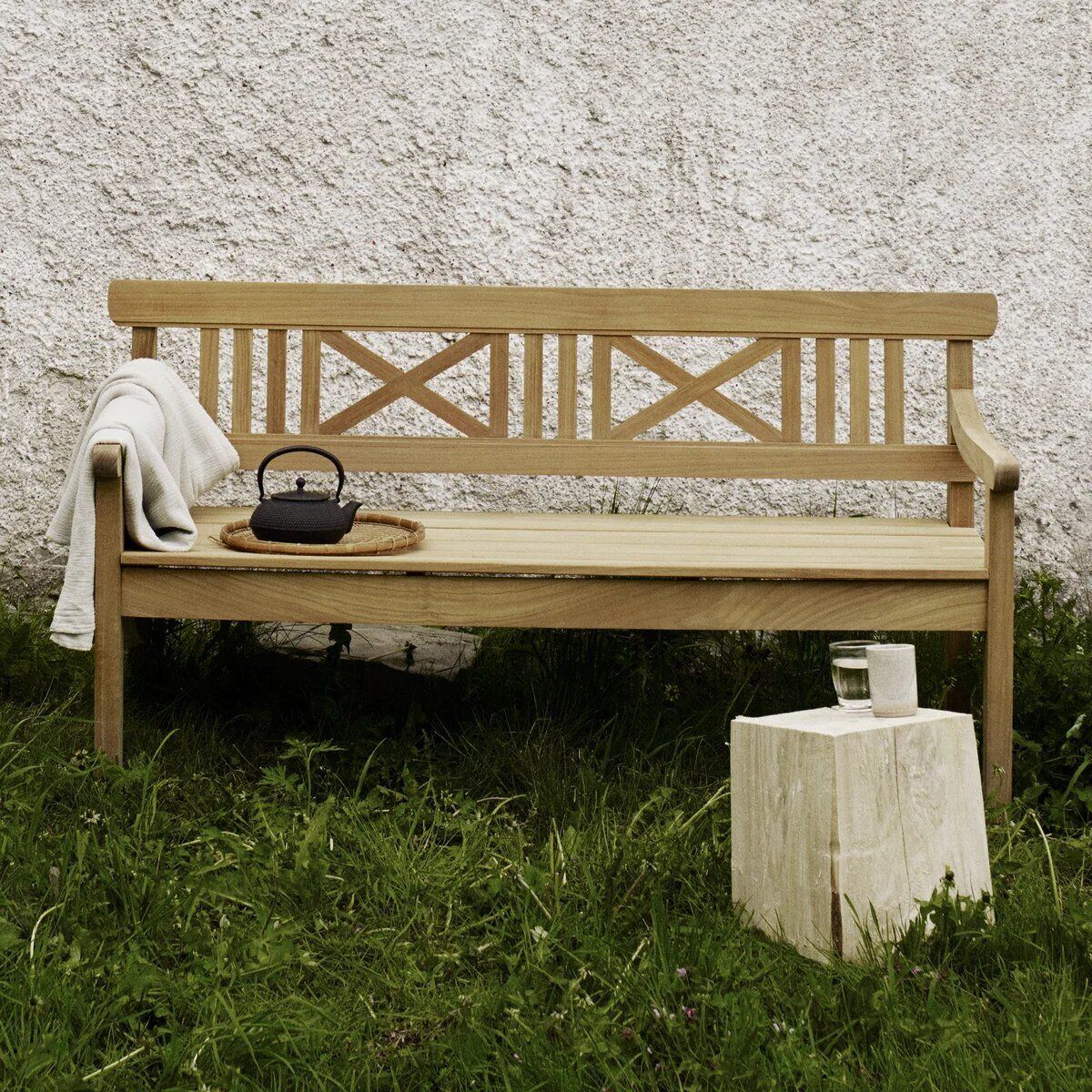 Drachmann teak dining table in an outdoor setting