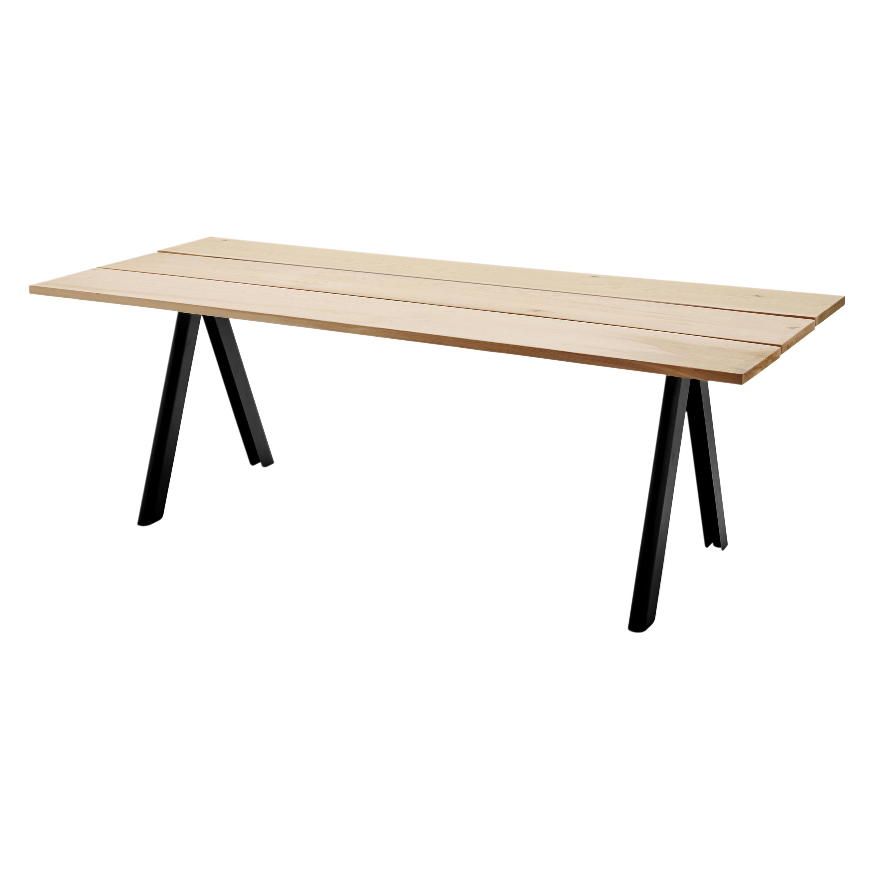 Overlap teak-and-steel dining table outdoors